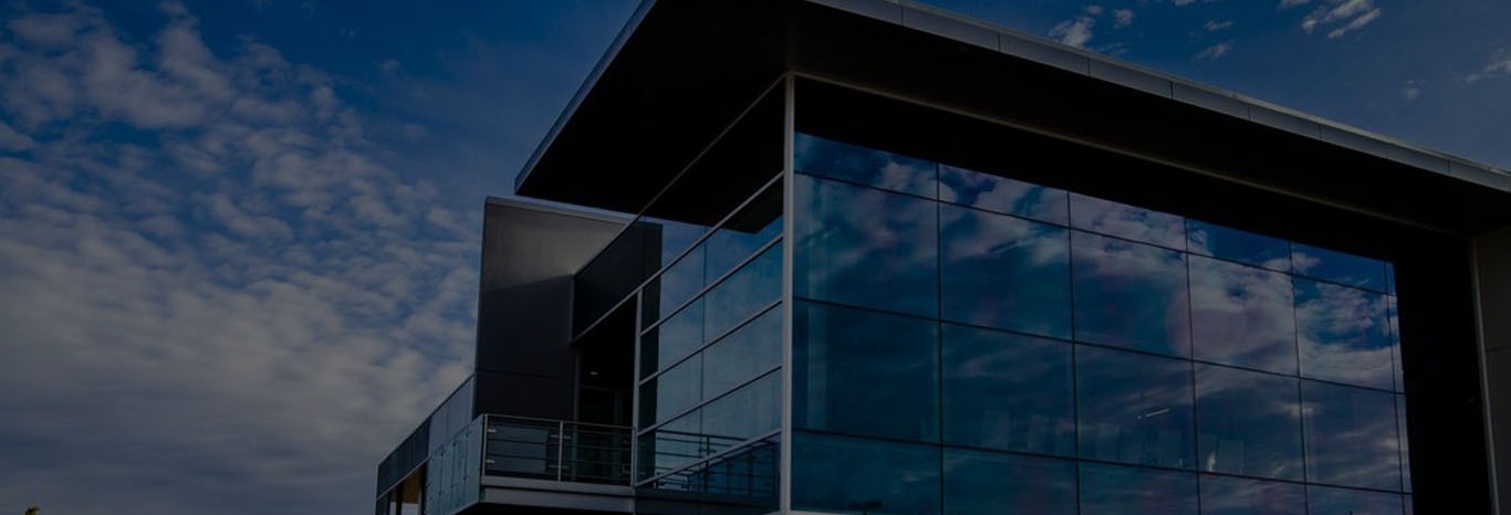 Architectural glass facade reflecting the sky